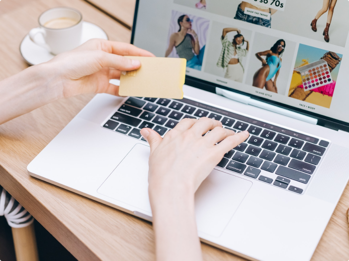 Woman shopping online holding credit card